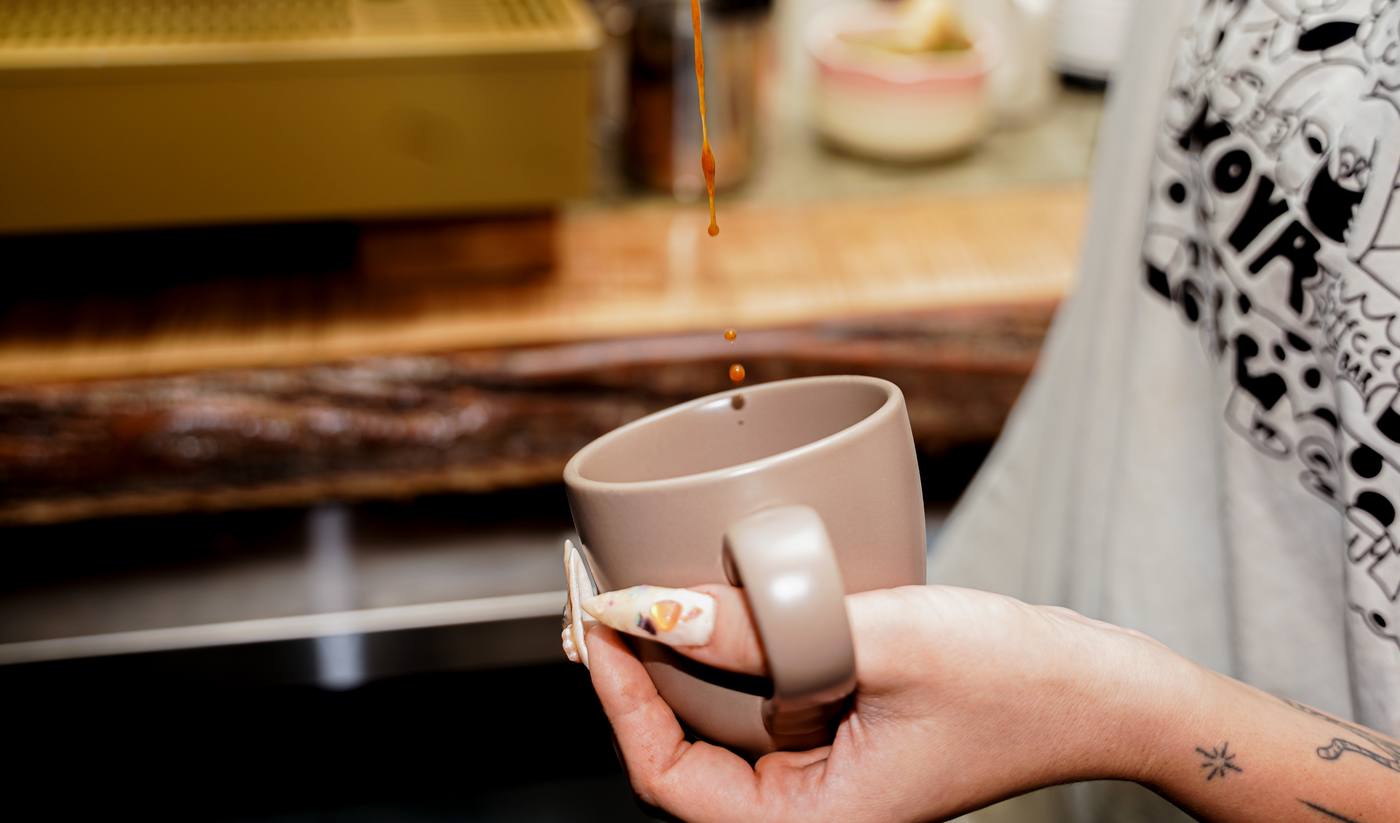 Espresso pouring in a thin stream at the Nova Cafe counter