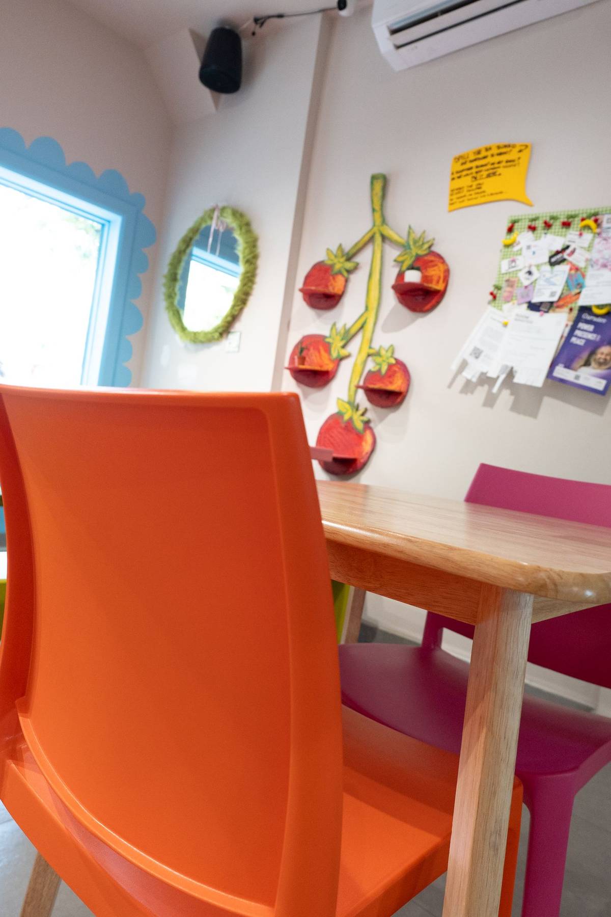 Colorful chairs and hand-painted tomato shelves